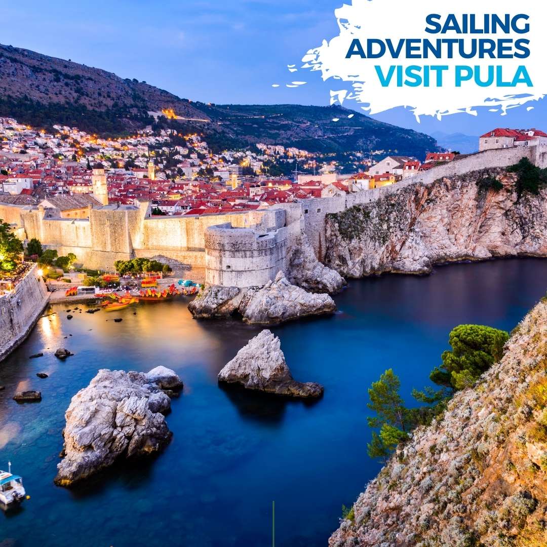 The city of Dubrovnik in Croatia at dusk with sailing yachting in a harbour.