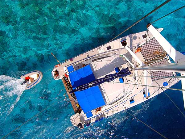 Amazing view to Catamaran cruising in open sea - birds eye angle