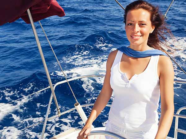 lady skipper navigating a sailboat.