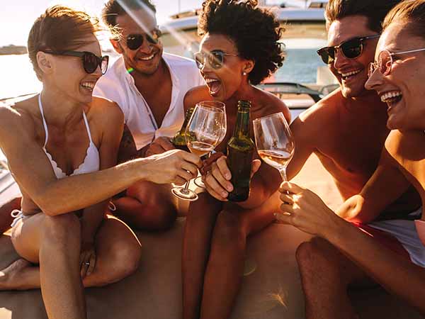 Friend drinking and laughing on a yacht cabin charter