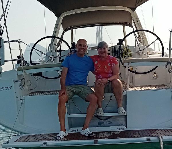 Crew mates on the stern of a yacht smiling