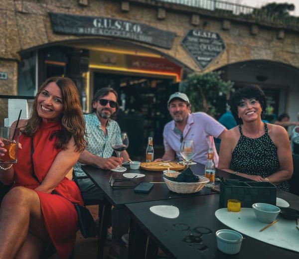 A group of friends smiling and sharing a meal