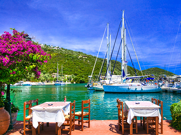 Traditional Greek restaurants (taverns) by the sea. Sivota fishing village in Lefkada island. Greece, Ionian islands