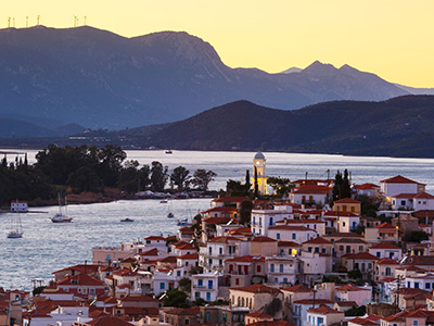 Poros, sunset over Peloponese peninsula mountains, Greece Yacht charter Sailing holiday Peloponnese flotilla 
