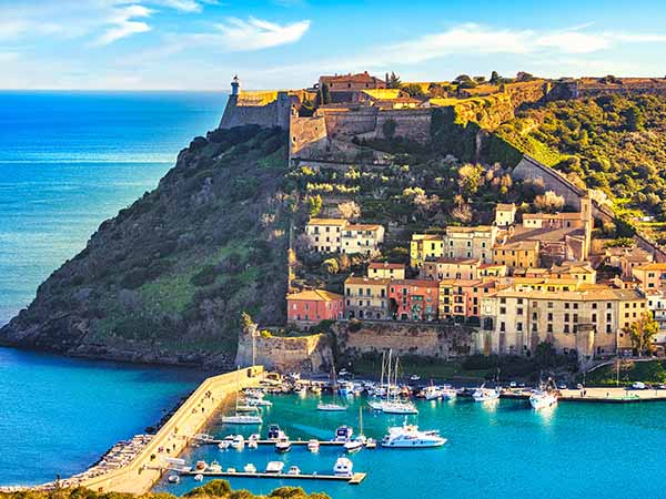 Porto Ercole village and boats in harbor in a sea bay. Aerial view. Monte Argentario, Maremma Grosseto Tuscany, Italy