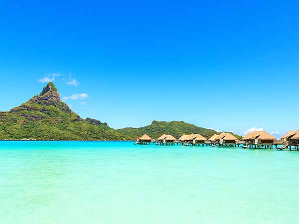 View on Mount Otemanu through turquoise lagoon and overwater bungalows on the tropical island Bora Bora, Tahiti, French Polynesia, Pacific ocean.