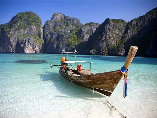 A long tail boat sits in Maya Bay, Koh Phi Phi Ley, Thailand.