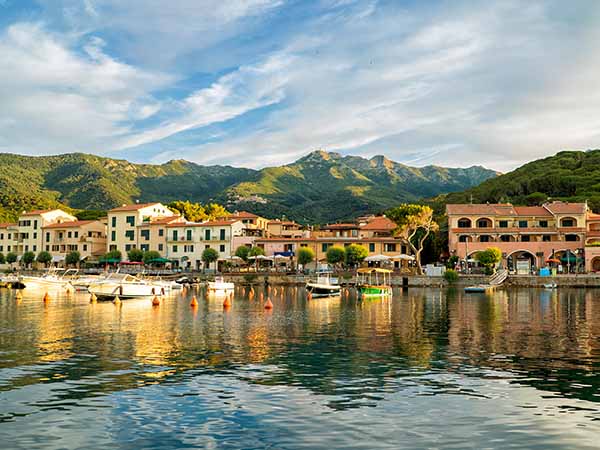 Marciana Marina, Italy - June 22, 2016: Coast of the Tyrrhenian Sea on the sunset. Marciana Marina is one of the most important towns of Elba Island in region of Tuscany, Italy