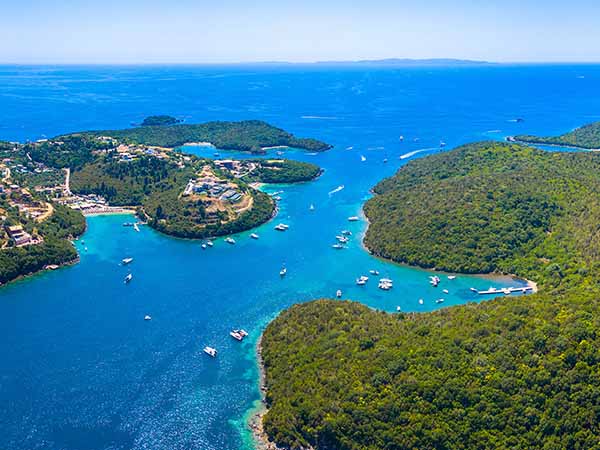 Aerial view of iconic paradise sandy beaches with turquoise sea in complex islands of Agios Nikolaos and Mourtos in Sivota area, Epirus, Greece