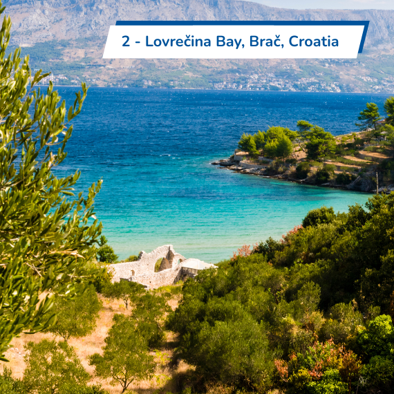 The city of Dubrovnik in Croatia at dusk with sailing yachting in a harbour.